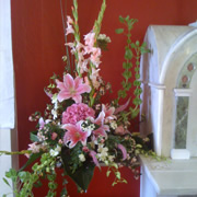 A hanging basket of pink roses and Daffodils